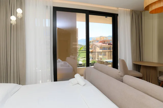 Bed and the door out to the balcony