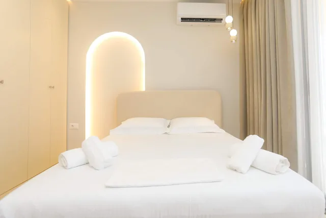 Bedroom with a lit arched alcove